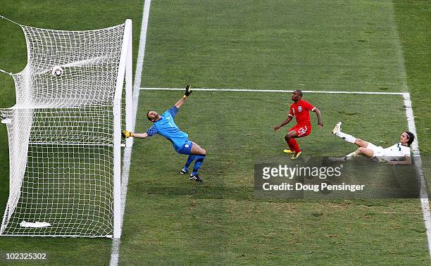 Jermain Defoe of England scores the opening goal past Samir Handanovic of Slovenia during the 2010 FIFA World Cup South Africa Group C match between...