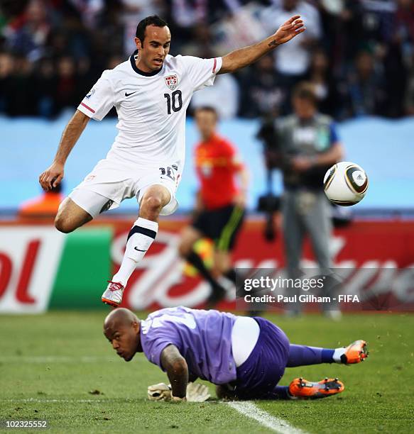 Landon Donovan of the United States jumps over Rais M'Bolhi of Algeria during the 2010 FIFA World Cup South Africa Group C match between USA and...