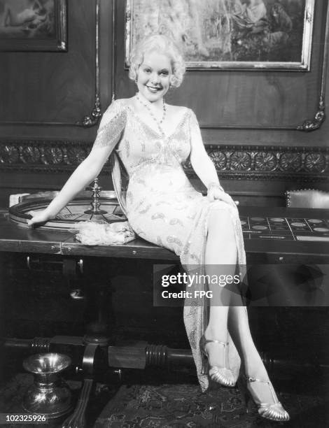 American actress and singer Alice Faye perches on a roulette table, 1934.