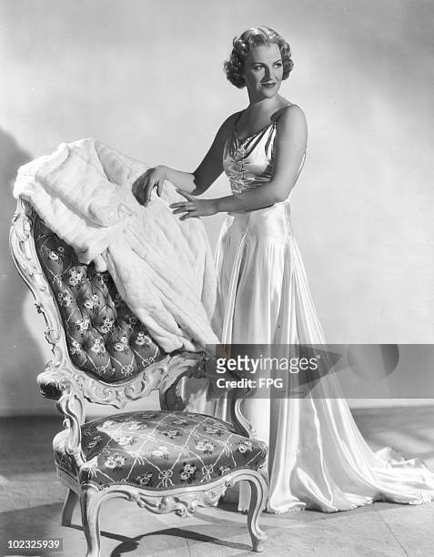 English actress Gracie Fields poses at the 20th Century Fox studios in a full-length evening gown, 1938. Already an established European star, she is...