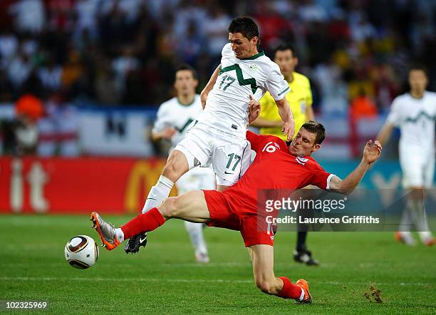 James Milner of England tackles Andraz Kirm of Slovenia during the 2010 FIFA World Cup South Africa Group C match between Slovenia and England at the...