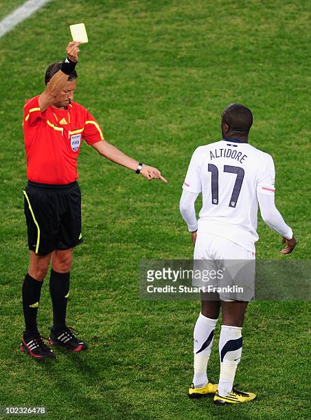 Jozy Altidore of the United States receives a yellow card from referee Frank de Bleeckere during the 2010 FIFA World Cup South Africa Group C match...