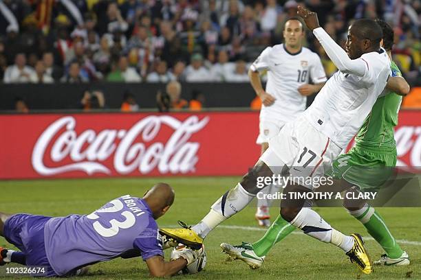 Algeria's goalkeeper M'bolhi Rais Ouheb grabs he ball from US striker Jozy Altidore during the Group C, first round, 2010 World Cup football match...