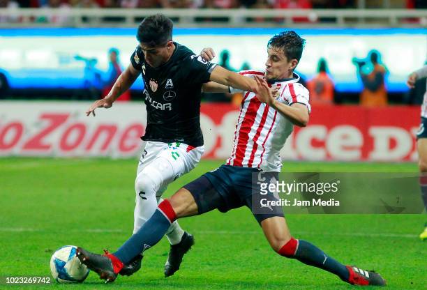 Jose Carlos Van Rankin of Chivas fights for the ball with Brian Fernandez of Necaxa duringduring the 6th round match between Chivas and Necaxa as...