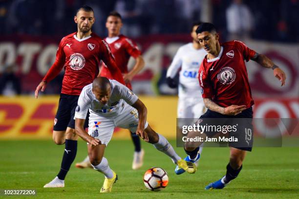 Carlos Sanchez of Santos fights for the ball with Pablo Hernandez of Independiente during a round of sixteen match between Independiente and Santos...