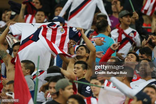 Fans of Chivas cheer on their team in the stands during the 6th round match between Chivas and Necaxa as part of the Torneo Apertura 2018 Liga MX at...