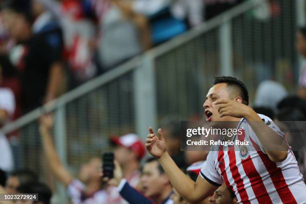 Fans of Chivas cheer on their team in the stands during the 6th round match between Chivas and Necaxa as part of the Torneo Apertura 2018 Liga MX at...