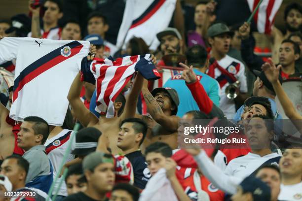 Fans of Chivas cheer on their team in the stands during the 6th round match between Chivas and Necaxa as part of the Torneo Apertura 2018 Liga MX at...