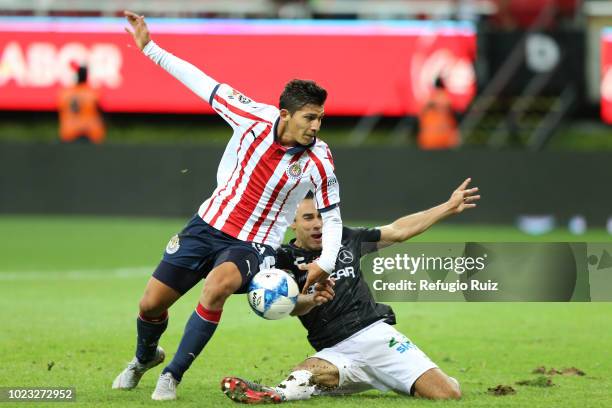 Angel Zaldivar of Chivas fights for the ball with Leobardo López of Necaxa during the 6th round match between Chivas and Necaxa as part of the Torneo...