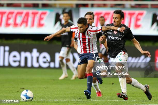 Orbelin Pineda of Chivas fights for the ball with Leobardo López of Necaxa during the 6th round match between Chivas and Necaxa as part of the Torneo...