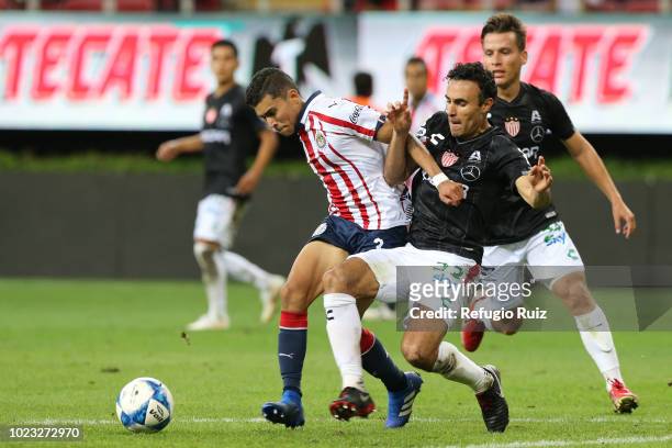 Orbelin Pineda of Chivas fights for the ball with Leobardo López of Necaxa during the 6th round match between Chivas and Necaxa as part of the Torneo...