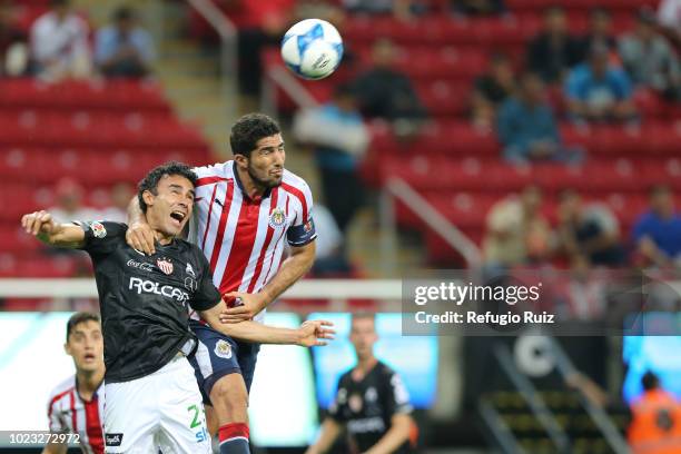 Jair Pereira of Chivas fights for the ball with Leobardo López of Necaxa during the 6th round match between Chivas and Necaxa as part of the Torneo...