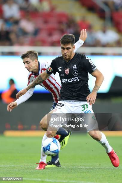 Isaac Brizuela of Chivas fights for the ball with Ventura Alvarado of Necaxa during the 6th round match between Chivas and Necaxa as part of the...