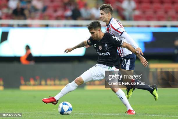 Isaac Brizuela of Chivas fights for the ball with Ventura Alvarado of Necaxa during the 6th round match between Chivas and Necaxa as part of the...