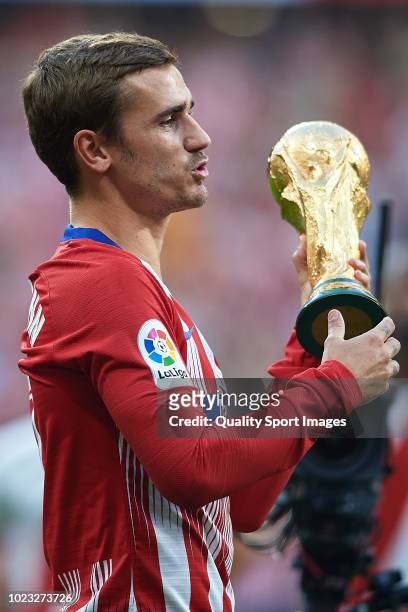 Antoine Griezmann of Atletico de Madrid poses with FIFA World Cup 2018 trophy prior to the La Liga match between Club Atletico de Madrid and Rayo...