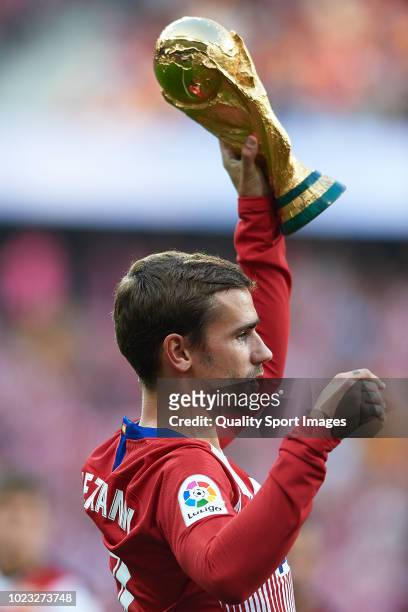 Antoine Griezmann of Atletico de Madrid poses with FIFA World Cup 2018 trophy prior to the La Liga match between Club Atletico de Madrid and Rayo...