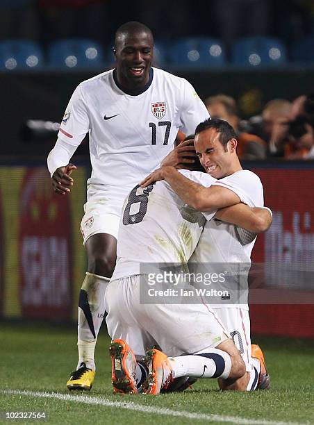 Landon Donovan of the United States celebrates scoring the winning goal with team mates Clint Dempsey and Jozy Altidore that sends the USA through to...