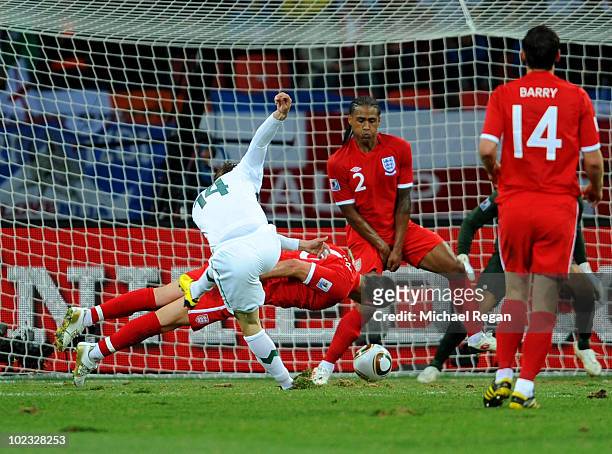 John Terry and Glen Johnson of England defend a shot by Zlatko Dedic of Slovenia during the 2010 FIFA World Cup South Africa Group C match between...