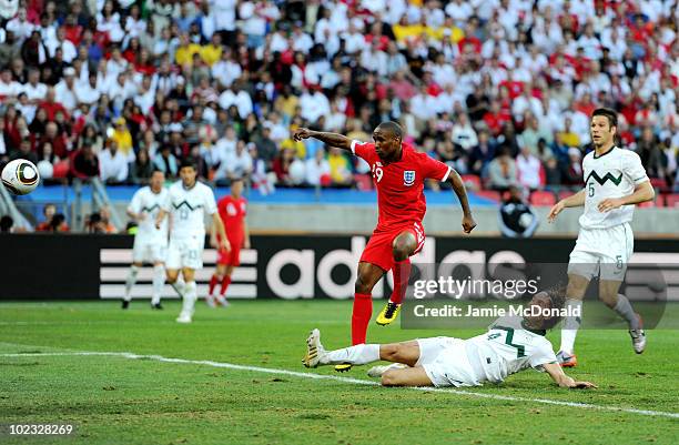 Jermain Defoe of England scores the opening goal under pressure from Marko Suler of Slovenia during the 2010 FIFA World Cup South Africa Group C...