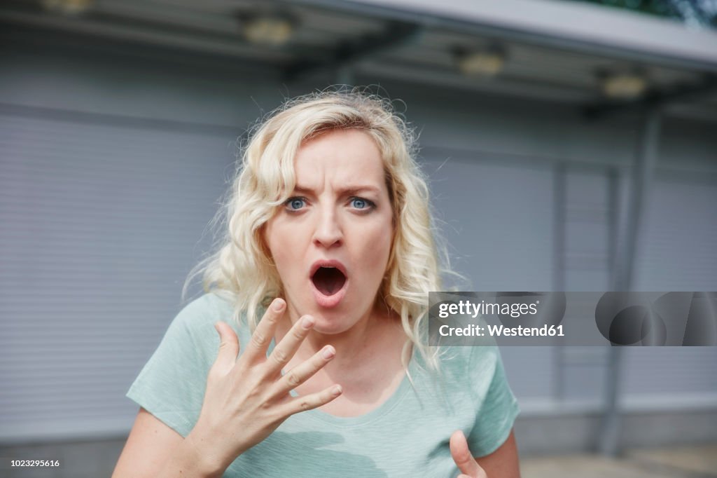 Portrait of shocked woman outdoors