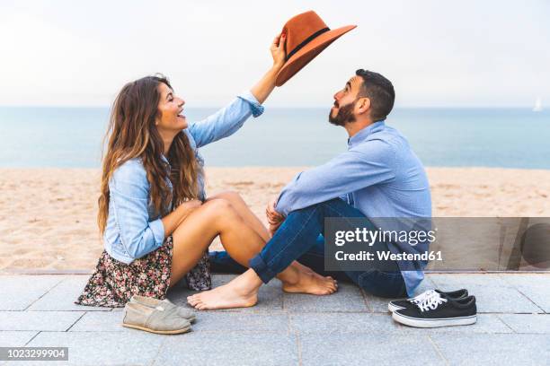 spain, barcelona, couple having fun together on the beach - happy couple flirt photos et images de collection