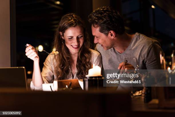 smiling couple having dinner together - intimate dinner ストックフォトと画像