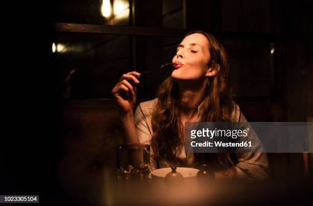 woman enjoying dinner - evening meal stock pictures, royalty-free photos & images