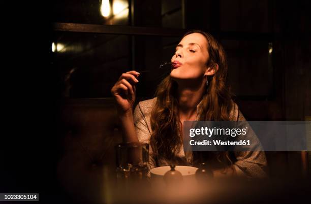 woman enjoying dinner - people having dinner restaurant stock pictures, royalty-free photos & images