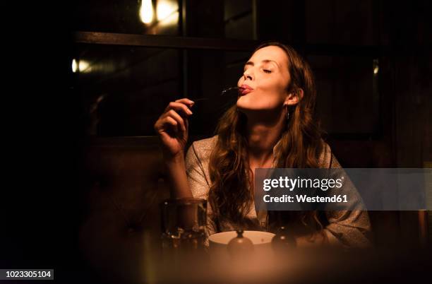 woman enjoying dinner - eyes closed bildbanksfoton och bilder