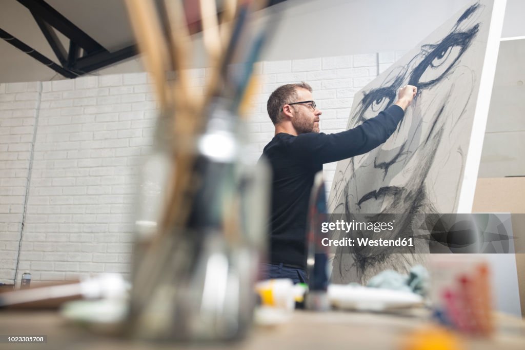 Man checking drawing in studio