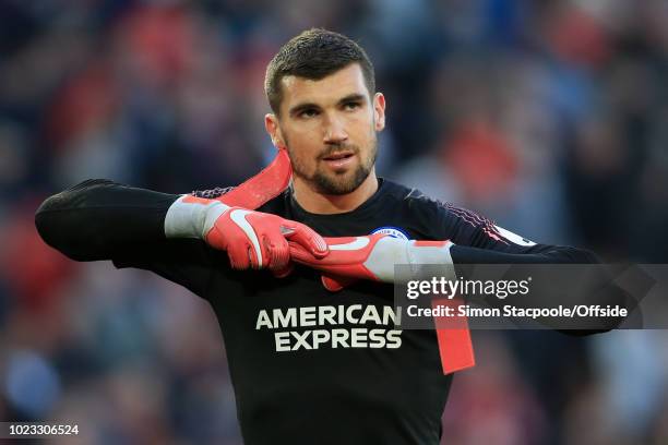 Brighton goalkeeper Mathew Ryan looks dejected as he removes his gloves after the Premier League match between Liverpool and Brighton & Hove Albion...