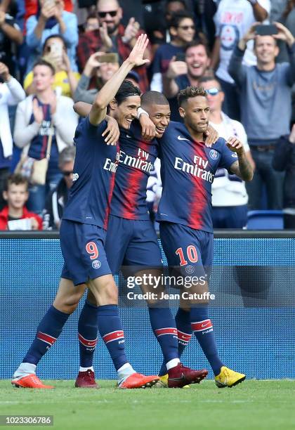 Kylian Mbappe of PSG celebrates his goal between Edinson Cavani and Neymar Jr during the french Ligue 1 match between Paris Saint-Germain and SCO...