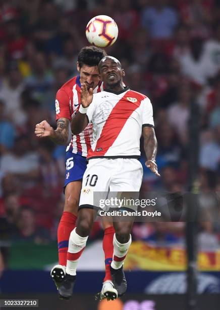 Gael Kakuta of Rayo Vallecano de Madrid is challenged by Stefan Savic of Club Atletico de Madrid during the La Liga match between Club Atletico de...