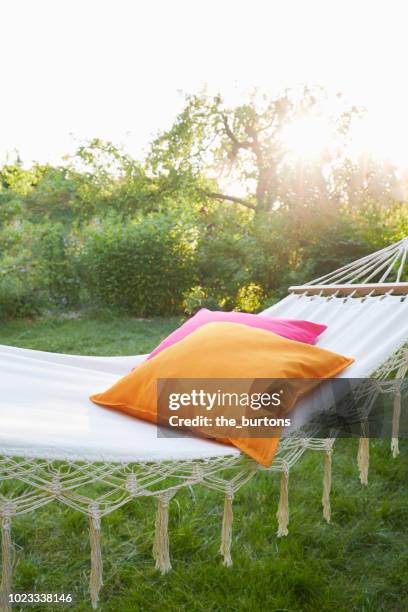 hammock with pillows in garden at sunset - travesseiro imagens e fotografias de stock