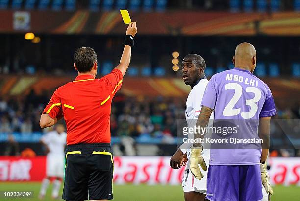 Jozy Altidore of the United States receives a yellow card by referee Frank de Bleeckere during the 2010 FIFA World Cup South Africa Group C match...