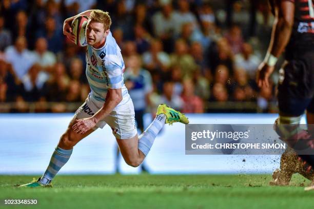 Racing92's Scottish fly-half Finn Russell runs with the ball to score try during the French Top 14 Rugby Union match between RC Toulon and Racing 92,...