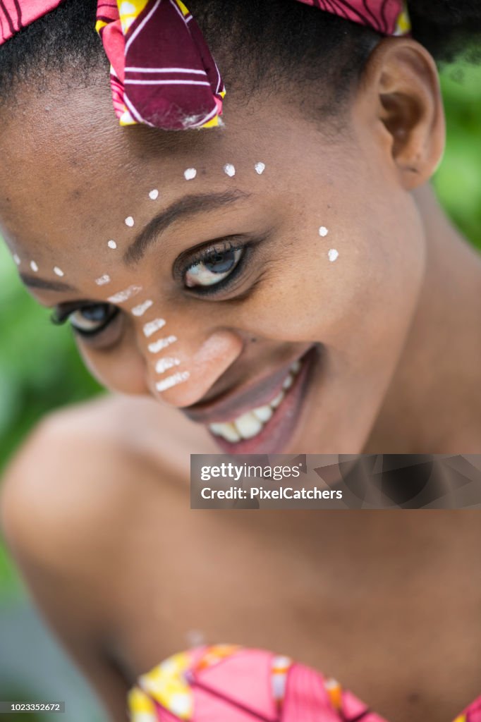 Portrait young African woman with traditional face paint