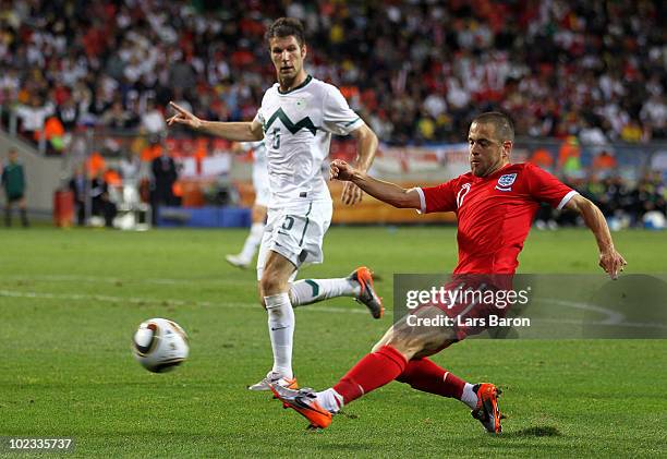 Joe Cole of England and Bostjan Cesar of Slovenia in action during the 2010 FIFA World Cup South Africa Group C match between Slovenia and England at...