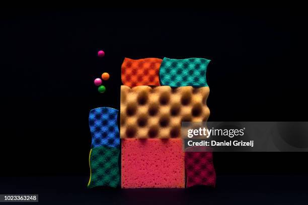 sponges piled up with marbles levitating around. - trabalho à base de remendos imagens e fotografias de stock
