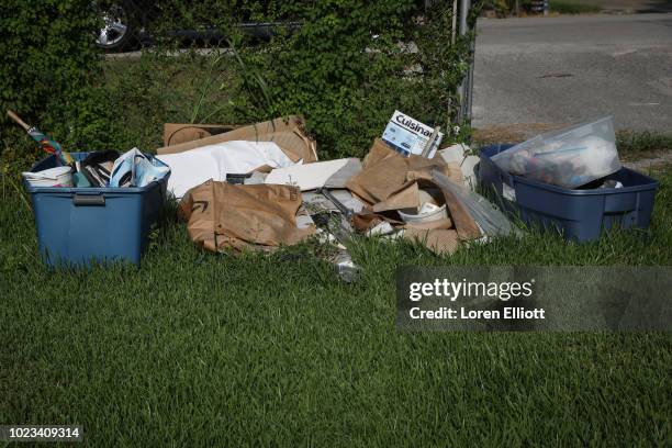 Debris is pictured in the yard of a home badly damaged by Hurricane Harvey in the Kashmere Gardens neighborhood on August 25, 2018 in Houston, Texas....