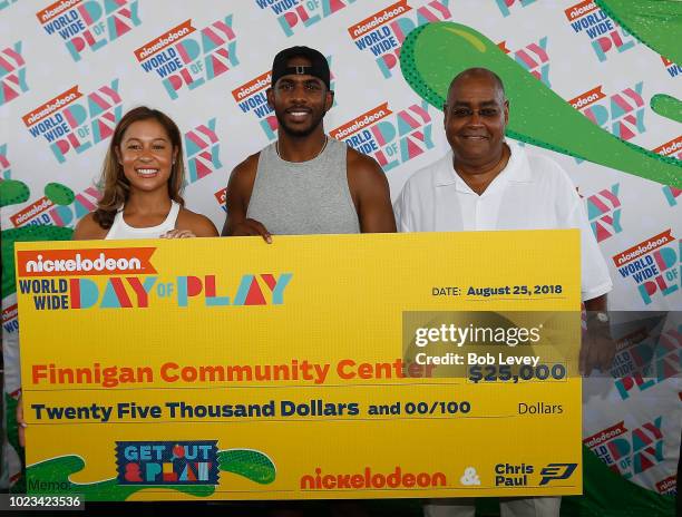 Nickelodeon's Sydney Cohn and Chris Paul of the Houston Rockets present grant to Finnigan Park Community Center on August 25, 2018 in Houston, Texas.