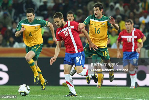 Milos Ninkovic of Serbia and Carl Valeri of Australia battle for the ball during the 2010 FIFA World Cup South Africa Group D match between Australia...