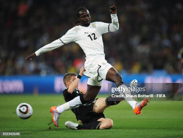 Prince Tagoe of Ghana is challenged by Bastian Schweinsteiger of Germany during the 2010 FIFA World Cup South Africa Group D match between Ghana and...