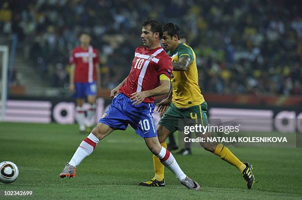Serbia's midfielder Dejan Stankovic fights for the ball with Australia's striker Tim Cahill during the Group D first round 2010 World Cup football...