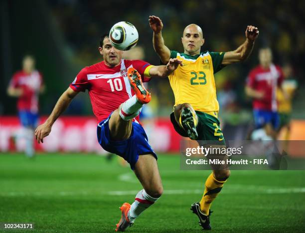 Dejan Stankovic of Serbia and Marco Bresciano of Australia tussle during the 2010 FIFA World Cup South Africa Group D match between Australia and...