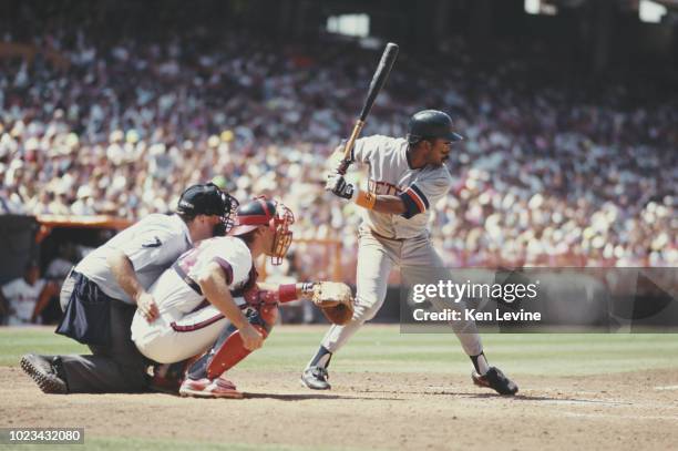 Home plate umpire Tim McClelland and Catcher Lance Parrish of the California Angels waits for the pitch as Tony Phillips, Outfielder, Second Baseman...