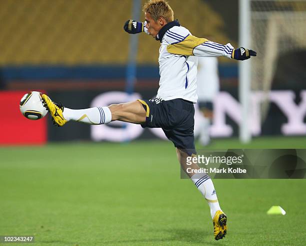 Keisuke Honda stretches for the ball at a Japan training session during the FIFA 2010 World Cup at Royal Bafokeng Stadium on June 23, 2010 in...
