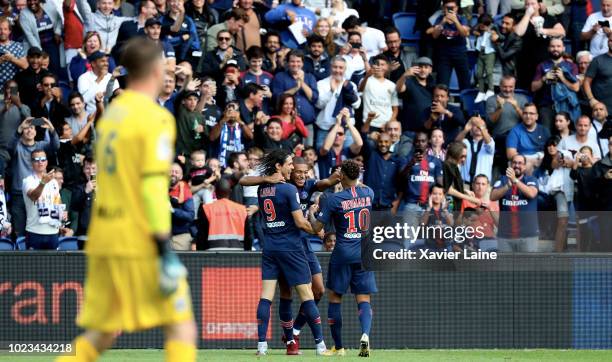 Kylian Mbappe of Paris Saint-Germain celebrate his goal with Edinson Cavani and Neymar Jr during the Ligue 1 match between Paris Saint-Germain and...