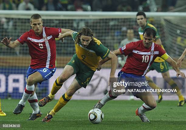 Australia's striker Josh Kennedy is challenged for the ball by Serbia's defender Nemanja Vidic and Serbia's midfielder Dejan Stankovic during the...