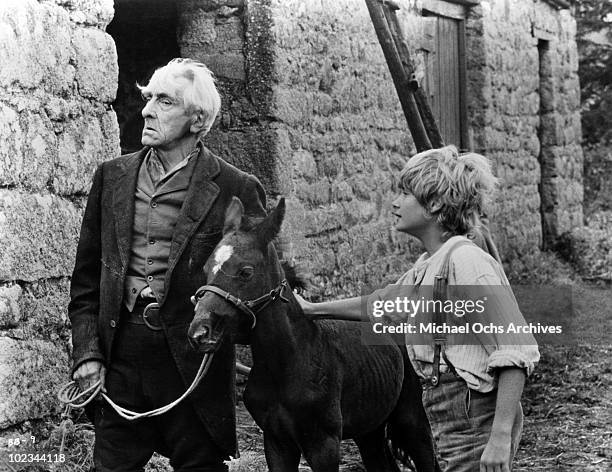 Joe Evans with his black stallion and a man in a scene from the movie "Black Beauty" which was released in 1971.